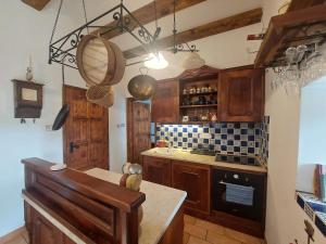 a kitchen with wooden cabinets and a counter top at Siske malom in Balatonfüred