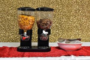 two black containers with food in them next to a bowl at Polka GuestHouse in Tshabong