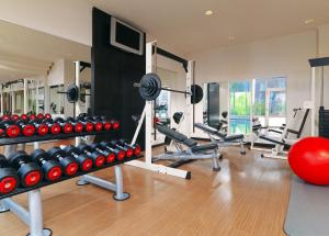 a gym with dumbbells and other equipment in a room at Heidelberg Marriott Hotel in Heidelberg +63 photos