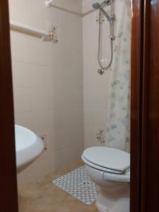 a bathroom with a toilet and a sink and a shower at Appartamento nel centro di porto azzurro in Porto Azzurro
