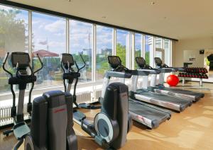 a gym with a row of cardio machines in a room at Heidelberg Marriott Hotel in Heidelberg