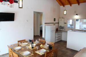 a kitchen and dining room with a table and chairs at Esquel Apart Chalet in Esquel +6 photos
