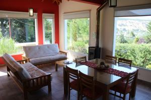 a living room with a table and chairs and a couch at Esquel Apart Chalet in Esquel