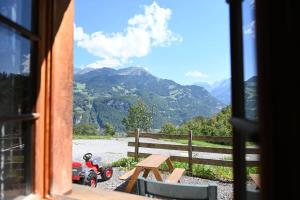 a window with a view of a motorcycle and mountains at Cozy Studio With Terrace Bbq Mountain View in Ober Stafel +22 photos