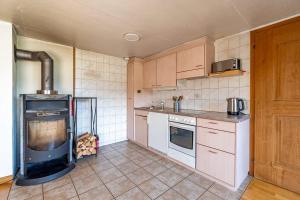 a kitchen with a stove and an oven in it at Cozy Studio With Terrace Bbq Mountain View in Ober Stafel
