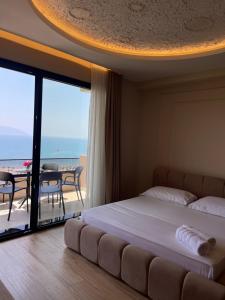 a bedroom with a bed with a view of the ocean at Seamare Studio & Apartaments in Vlorë