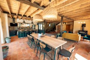 a large dining room with a wooden table and chairs at Gîte Le Rivalou - Grazac - Tarn in Grazac