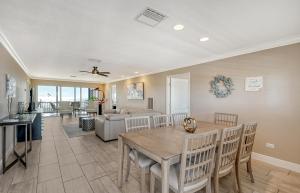 a dining room and living room with a table and chairs at Crescent Royale Condominiums 501 in Siesta Key