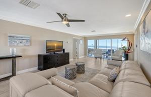 a living room with a couch and a flat screen tv at Crescent Royale Condominiums 501 in Siesta Key