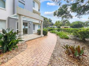 a brick walkway in front of a house at Relaxing Ocean Views Beachside at Buddina in Buddina