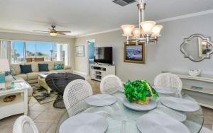 a living room with a glass table and chairs at Crescent Royale Condominiums 201 in Siesta Key