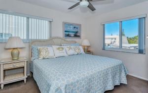 a bedroom with a bed and a large window at Crescent Royale Condominiums 201 in Siesta Key +47 photos