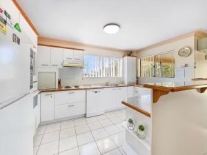 a kitchen with white cabinets and a counter top at 2BRM Self Contained Apt - Pumicestone Passage View in Bellara