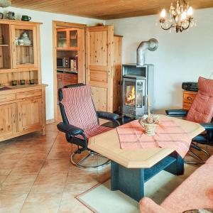 a living room with a table and a fireplace at Bungalow 1 in Quetzin