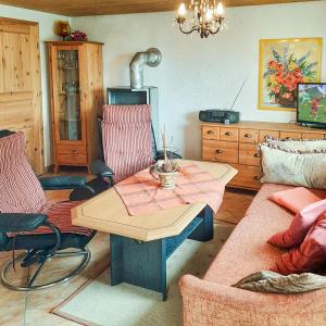 a living room with a table and a couch at Bungalow 1 in Quetzin