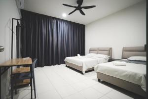 a bedroom with two beds and a ceiling fan at HM Residence 11pax Setia City Convention in Shah Alam