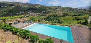 a swimming pool on the side of a house at Quinta do Santo no Douro - Casa T2 in Alcarias