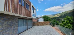 a balcony of a house with a glass door at Quinta do Santo no Douro - Casa T2 in Alcarias