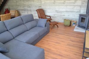 a living room with a couch and a chair at Quinta do Santo no Douro - Casa T2 in Alcarias