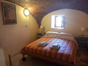 a bedroom with a bed with two bags on it at La SELVA in Vistrorio +75 photos