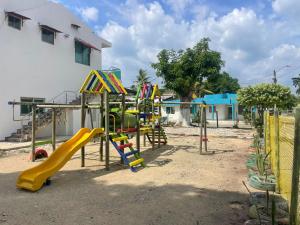 a playground with a yellow slide at Habitaciones Melany in Coveñas