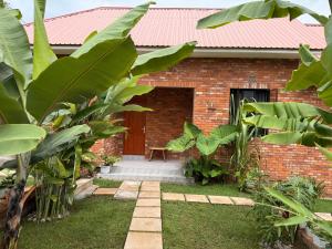 a red brick house with a red roof at Baraka Home in Arusha