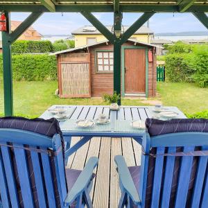 a table with two blue chairs on a wooden deck at Bungalow 2 in Quetzin
