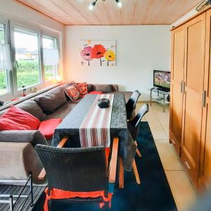 a living room with a table and a couch at Bungalow 2 in Quetzin