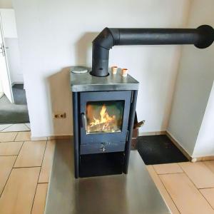 a stove with a fire in a room at Bungalow 2 in Quetzin +17 photos