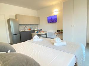 a bedroom with a white bed with towels on it at Suite Emilia 8 in Bologna