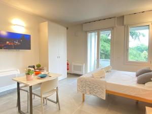 a bedroom with a bed and a table and a desk at Suite Emilia 8 in Bologna