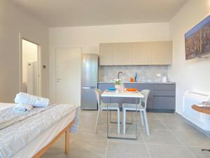 a kitchen with a table and chairs in a room at Suite Emilia 8 in Bologna +13 photos
