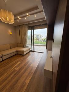 a living room with a couch and a table at villa c182 in Sheikh Zayed +19 photos