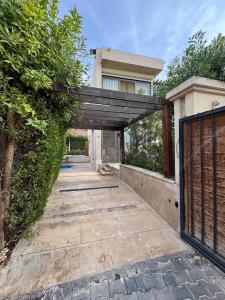 an entrance to a house with a wooden gate at villa c182 in Sheikh Zayed