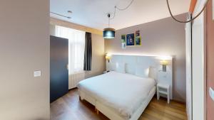 Postel nebo postele na pokoji v ubytování greet hotel Lille Gare Flandres - Groupe Accor