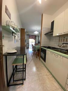 a kitchen with a counter and a table in it at Villetta Da Gilda nel cuore del Salento! in San Foca