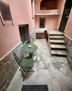 a patio with a table and a chair and stairs at Monolocale nuovo in centro storico in Levanto