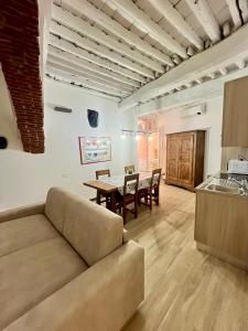 a living room with a couch and a table at Monolocale nuovo in centro storico in Levanto