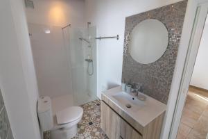 a bathroom with a toilet and a sink and a mirror at Casa Jana 5 Bedroom House for 12 with Ocean View Terrace near the Beach in Burgau