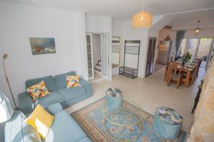 a living room with a blue couch and a table at Casa Jana 5 Bedroom House for 12 with Ocean View Terrace near the Beach in Burgau +27 photos