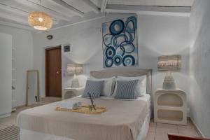 a bedroom with a large bed with a tray on it at Amouage Boutique Home in Skiathos Town