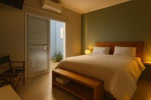 a bedroom with a large bed and a window at Villa Brotas in Brotas +27 photos