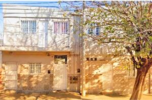 an old building with a tree in front of it at A&C Temporarios II in Corrientes
