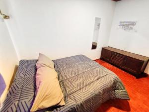a bedroom with a bed and a dresser at A&C Temporarios II in Corrientes