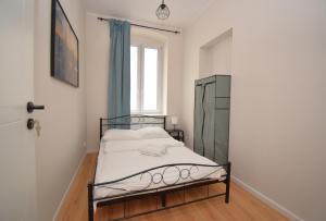 a small bedroom with a bed and a window at roomspoznan pl - Pokoje Rybaki 29 - 24h self check-in in Poznań +29 photos