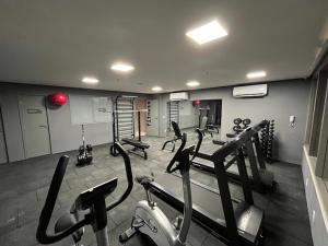a gym with several treadmills and machines at Simple Smart João Pessoa in João Pessoa