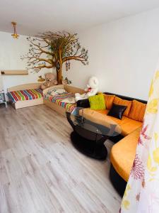 a living room with a couch with stuffed animals on it at Elisea apartment in Ruse