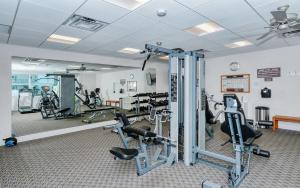 a gym with treadmills and machines in a room at Crescent Royale 415 in Siesta Key