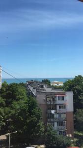 a tall building with trees in front of it at Apartment on Parkovaya in Chornomorsk