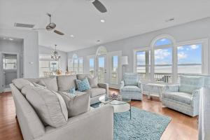 een woonkamer met een bank, twee stoelen en een tafel bij Ocean View Pool Waterslide Elevator & Firepit in Oak Island